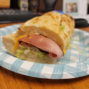 a sandwich on a paper plate