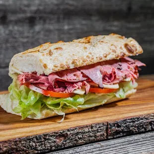 a roast beef sandwich on a cutting board
