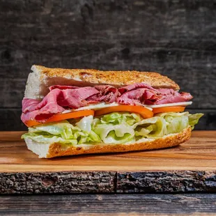 a roast beef sandwich on a cutting board
