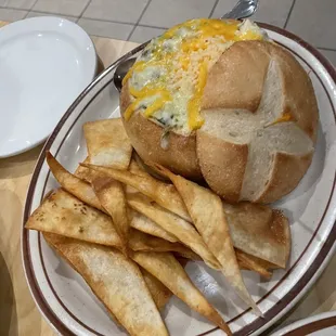 Spinach and artichoke dip In bread bowl