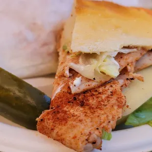 a chicken sandwich with a pickle