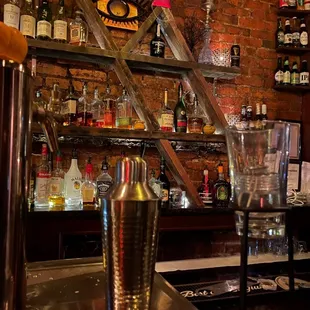 a bar with liquor bottles on the shelves