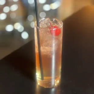 a drink with a cherry on top