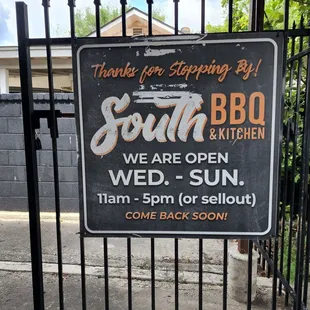 a sign in front of a gate