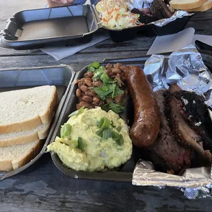 BBQ plate with brisket, sausage, borracho beans, and potato salad
