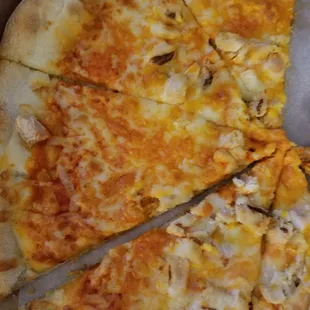 Undercooked pizza that's missing chicken