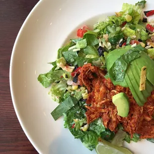 Cowboy salad with pulled adobo chicken, avocado and lettuce.