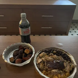 Slow cooked pork with rice and beans.   Side of fried plantains.    Always perfect.