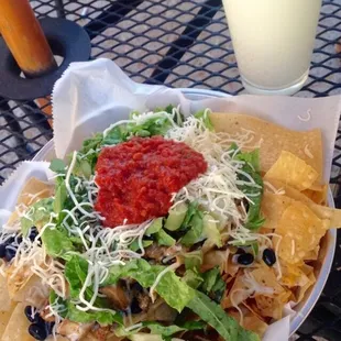Nachos w/ chicken, rice, black beans, lots of queso, lettuce, cheese, mild salsa &amp; two limes + marg. 10/10
