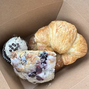 Lemon blueberries scone, chocolate chip cupcake, and a butter croissant