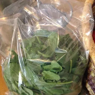 a basket of spinach and a basket of lettuce