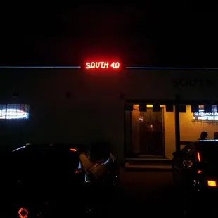 a neon sign on the side of a building