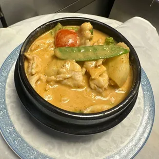 a bowl of chicken curry on a plate