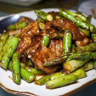 a plate of stir fried asparagus