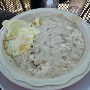 This was the pint size  biscuits and gravy. 1 large biscuit with a heaping of sausage gravy served with over medium eggs