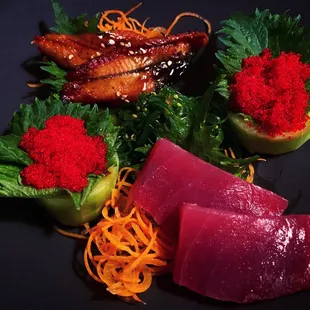 unagi, tobiko, maguro sashimi along with seaweed salad.