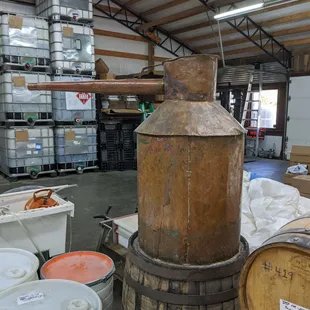 a copper pot and barrels