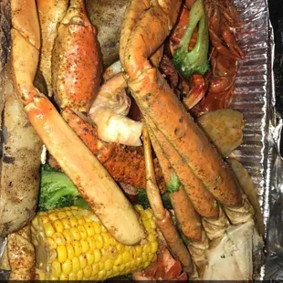 Crawfish, crab legs, shrimp, broccoli , corn, and potatoes