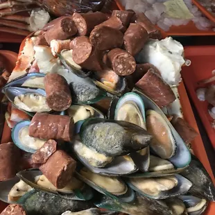 a tray of mussels and sausages