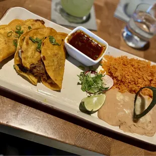 Birria Beef Tacos with Spanish Rice and Purred Refried Beans...