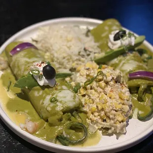Seafood enchiladas in a pablano cream sauce .