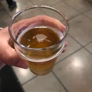 a person holding a glass of beer