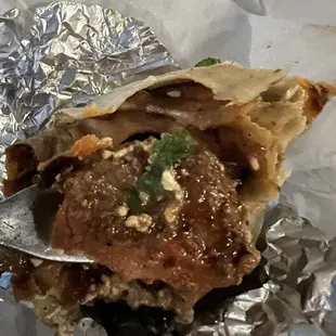 Burrito with extremely large pieces of meat.