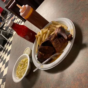 a plate of ribs, fries, coleslaw and ketchup