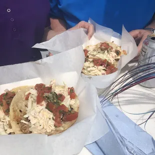 two tacoss on a table