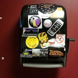 a toaster with stickers on it