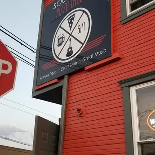 a stop sign in front of a red building