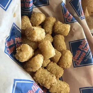a basket of fried cheese steaks