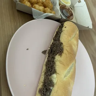 Philly Cheesesteak with onions and a side of tots