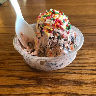 Single scoop Black Cherry Amaretto Mackinac Island Fudge with Rainbow Sprinkles.