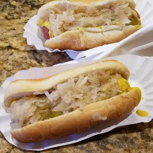 Two Vienna Beef hot dogs with mustard, relish, and sauerkraut. They are $1.50 each.