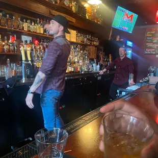 a man holding a glass of whiskey