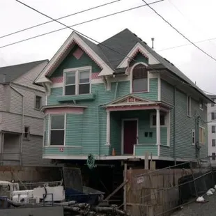 a house that has been lifted by a truck