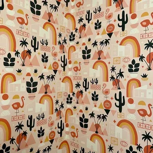 a shower curtain with a pattern of flamingos, palm trees, and rainbows