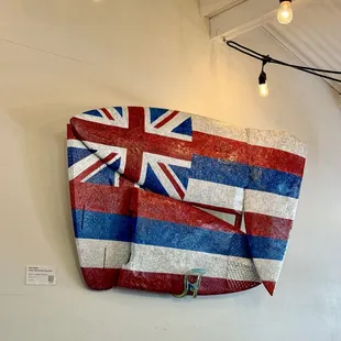 very cool Hawaiian flag made from pieces of a surfboard
