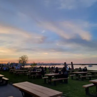 a group of people sitting at picnic tables