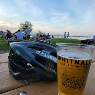 a pint of beer next to a helmet