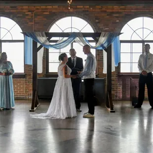 Saying I do in front of a line of windows overlooking the lake and downtown!