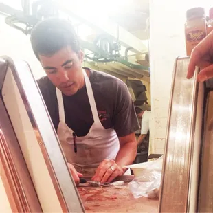 Nice Butcher showing us how to butterfly our shrimp!