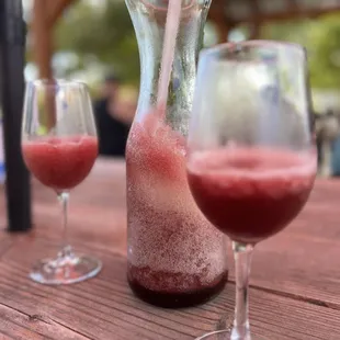 a pitcher and two glasses of wine
