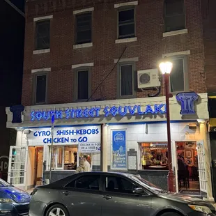 a car parked in front of a restaurant