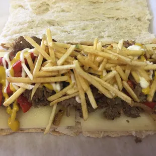 a sandwich with cheese and fries