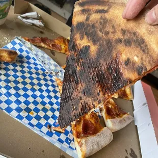 Burnt pepperoni pizza