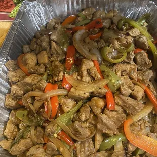 beef and peppers in a foil container