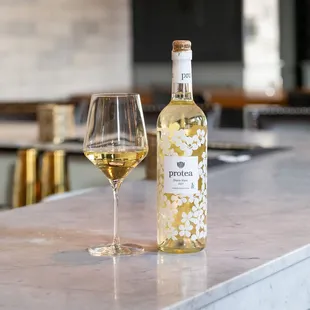 a glass and bottle of white wine