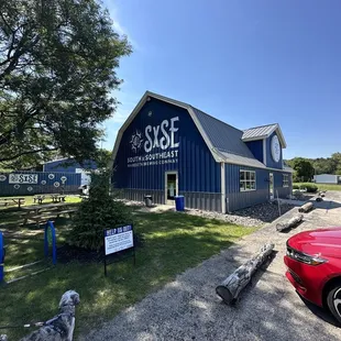 a red car parked in front of a blue building